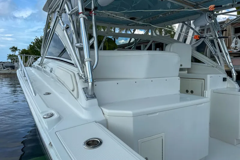 Slide: The Image of 2009 Jupiter 39 Express boat with sleek white design and chrome details docked by the water. - 8