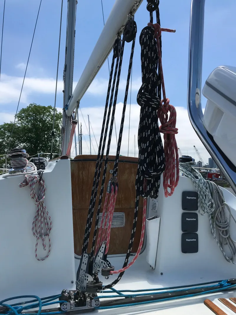 Slide: The Image of 1993 Beneteau First 310 sailboat deck with rigging and ropes. - 15