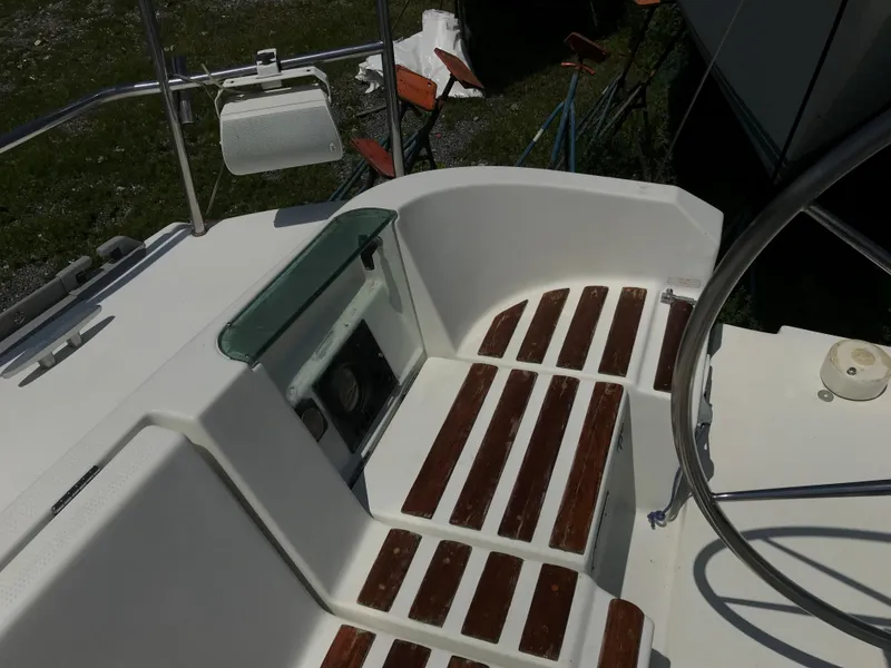 Slide: The Image of Cockpit of 1993 Beneteau First 310 sailboat with wooden slatted seating. - 22