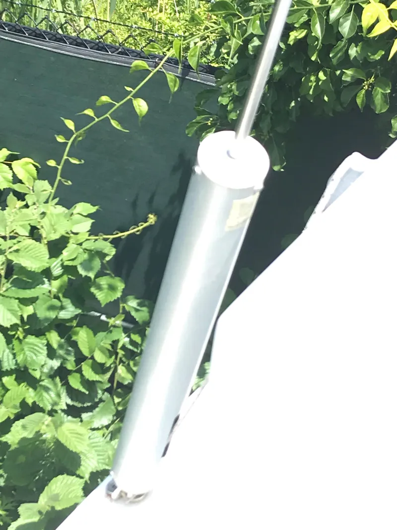 Slide: The Image of Close-up of a Beneteau First 310 sailboat component, surrounded by greenery. - 24