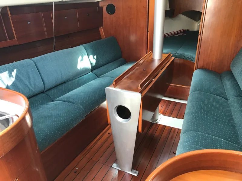 Slide: The Image of Interior of 1993 Beneteau First 310 sailboat with wood finish and teal seating. - 31
