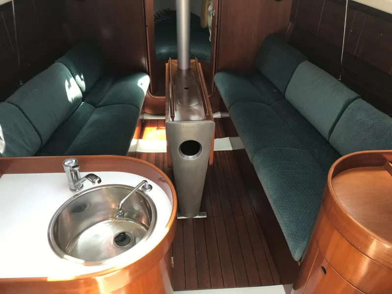 Slide: The Image of Interior of 1993 Beneteau First 310 sailboat with wood finish and compact kitchenette. - 33