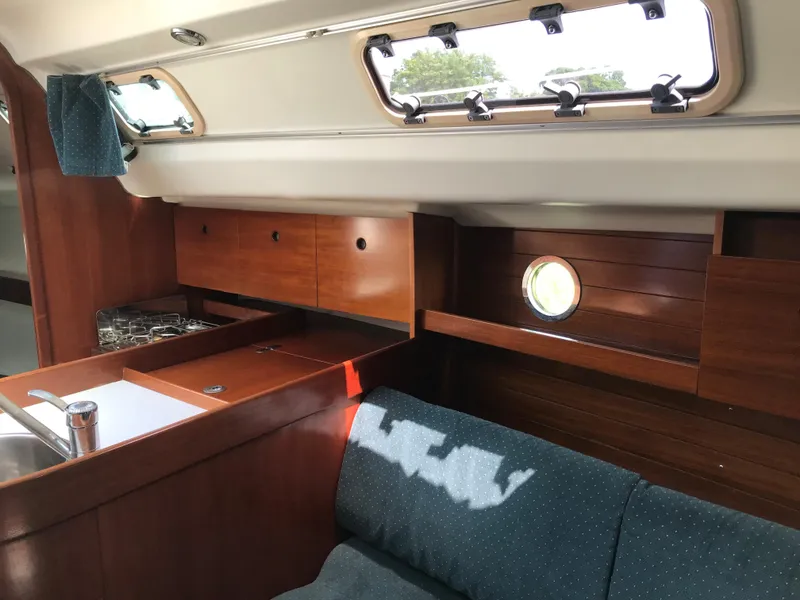 Slide: The Image of Interior of 1993 Beneteau First 310 sailboat with wooden cabinetry and seating. - 34