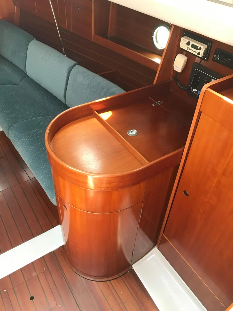 Slide: The Image of Interior of 1993 Beneteau First 310 sailboat with wooden cabinetry and seating area. - 38