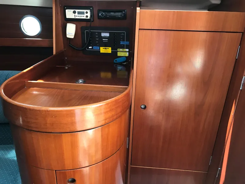 Slide: The Image of Interior of 1993 Beneteau First 310 sailboat with wooden cabinetry and navigation equipment. - 39