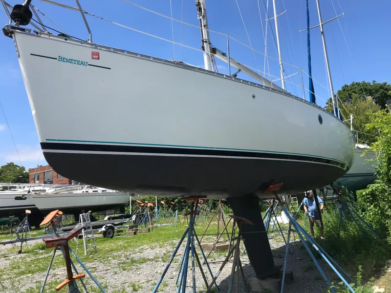 Slide: The Image of 1993 Beneteau First 310 sailboat on stands in a boatyard. - 4