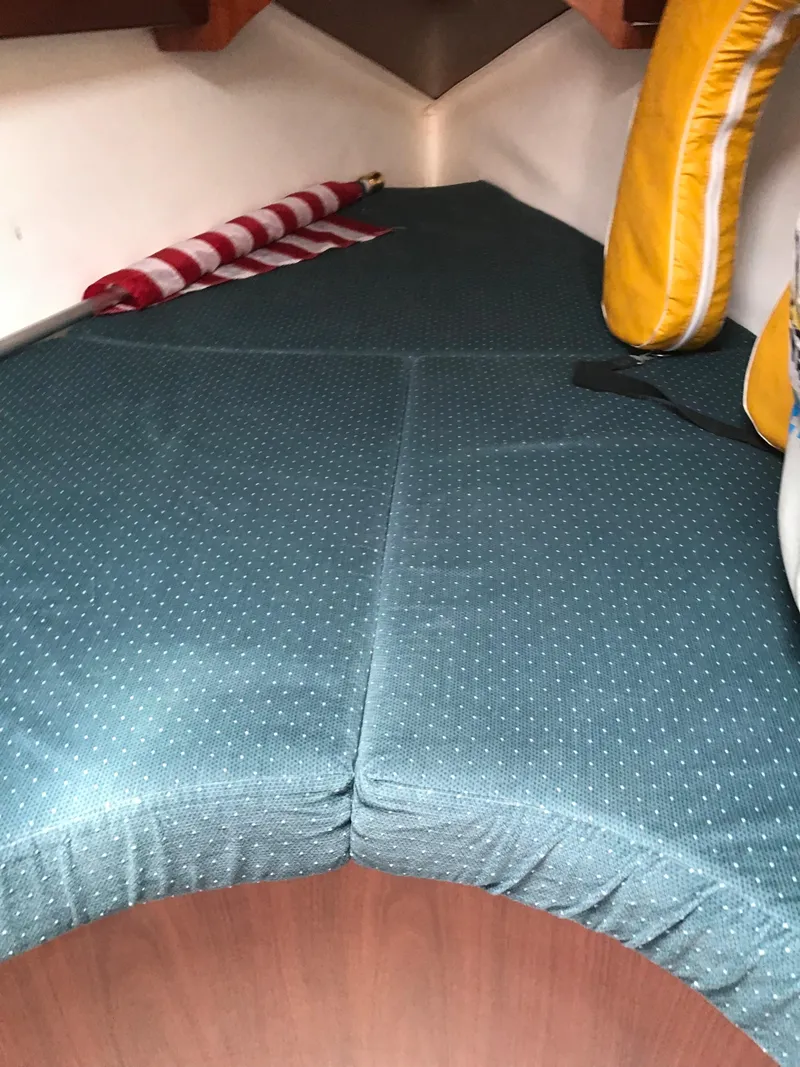 Slide: The Image of Interior cabin of 1993 Beneteau First 310 sailboat with blue cushions and safety equipment. - 45