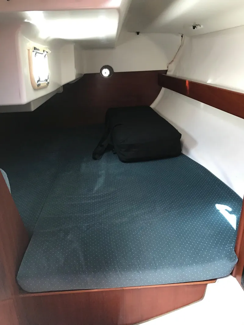 Slide: The Image of Cozy cabin interior of 1993 Beneteau First 310 sailboat with cushioned bed. - 47