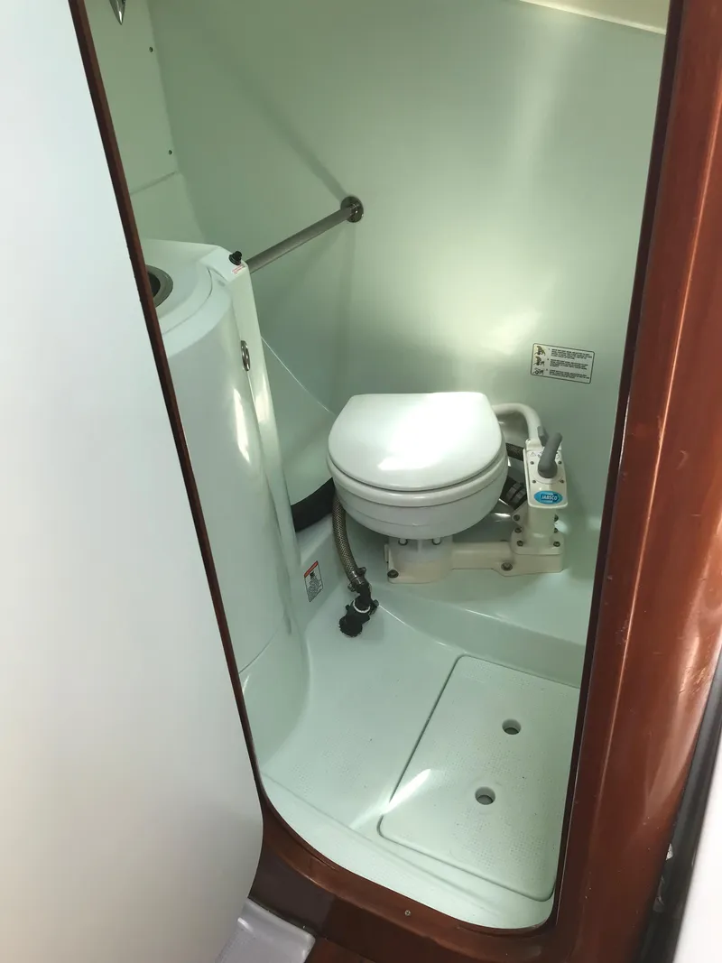 Slide: The Image of Compact bathroom in 1993 Beneteau First 310 sailboat with toilet and storage. - 49