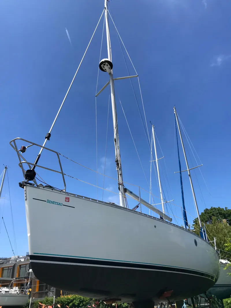 Slide: The Image of 1993 Beneteau First 310 sailboat under clear blue sky. - 5