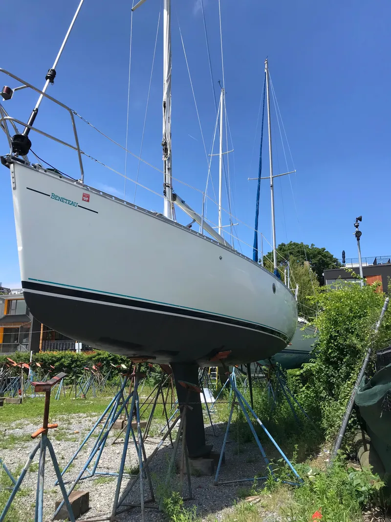 Slide: The Image of 1993 Beneteau First 310 sailboat on stands, clear sky background. - 6