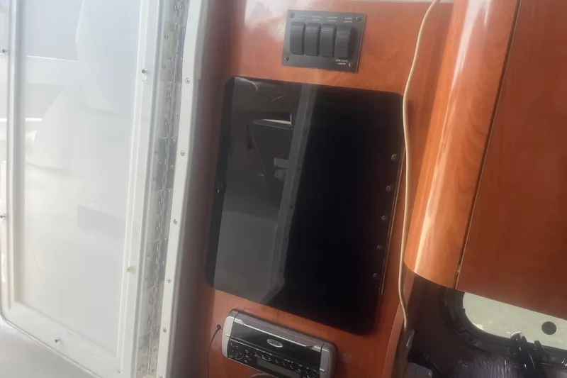 Slide: The Image of 2004 Four Winns 268 Vista interior with control panel and wood finish. - 11