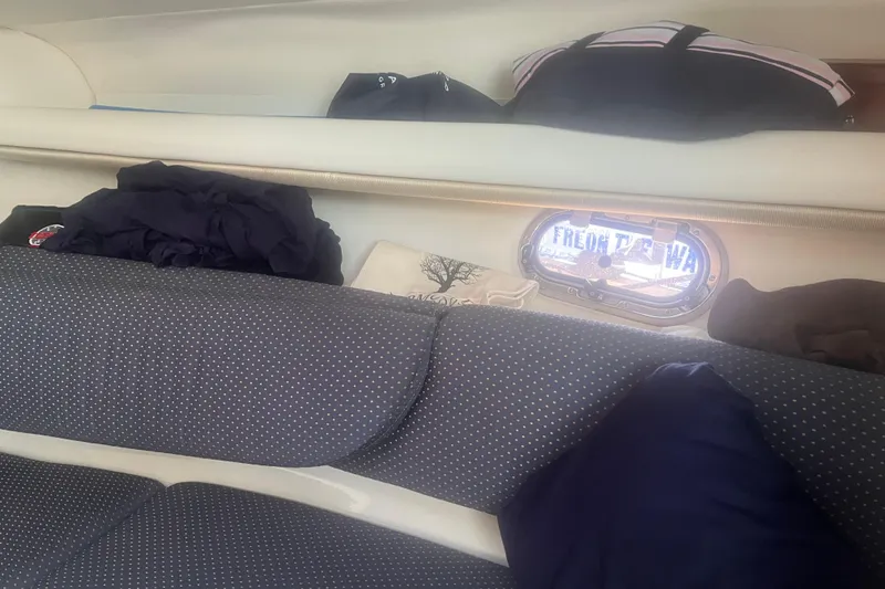 Slide: The Image of Interior of 2004 Four Winns 268 Vista boat with cushions and storage area. - 19