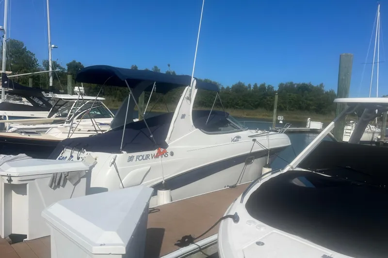 Slide: The Image of 2004 Four Winns 268 Vista boat docked at marina under clear blue sky. - 2