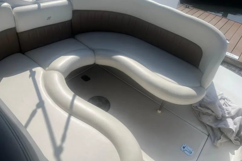 Slide: The Image of 2004 Four Winns 268 Vista boat interior with curved seating and beige upholstery. - 20