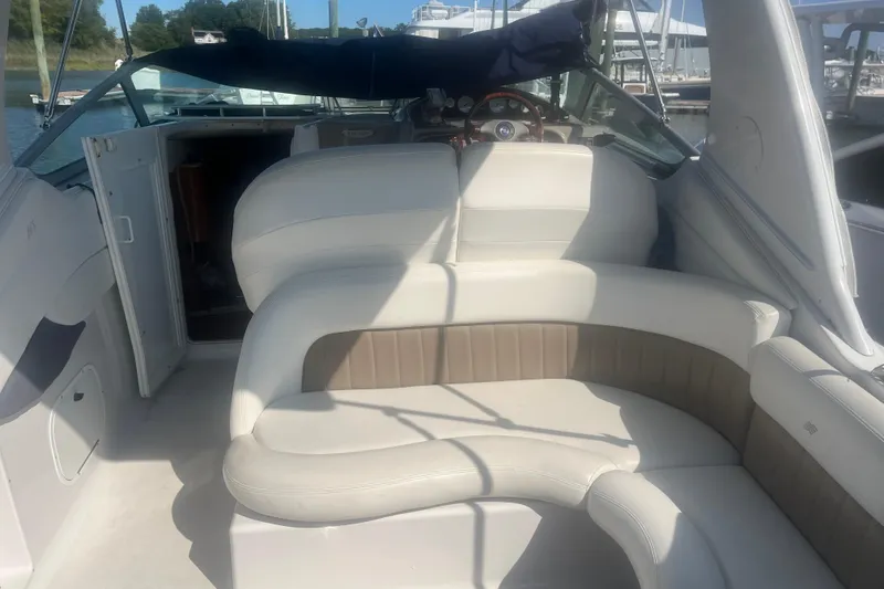 Slide: The Image of 2004 Four Winns 268 Vista boat interior with white seating and open cabin door. - 21