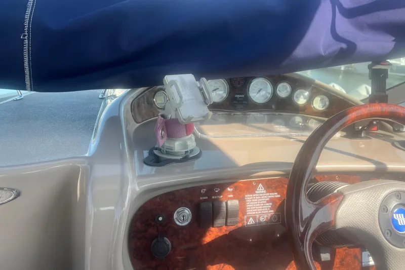 Slide: The Image of 2004 Four Winns 268 Vista boat dashboard with steering wheel and instrument panel. - 24