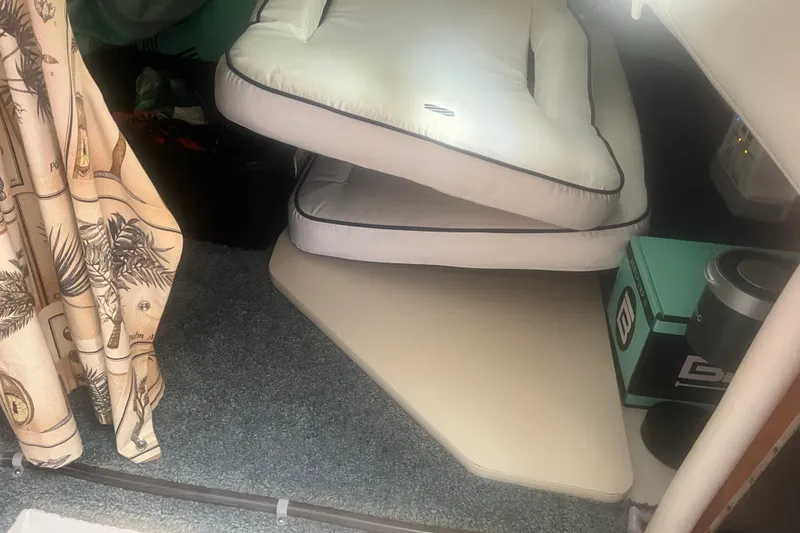 Slide: The Image of Interior of 2004 Four Winns 268 Vista boat with cushions and patterned curtain. - 25