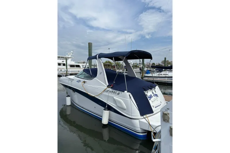 Slide: The Image of 2004 Four Winns 268 Vista boat docked at marina, blue and white design. - 39