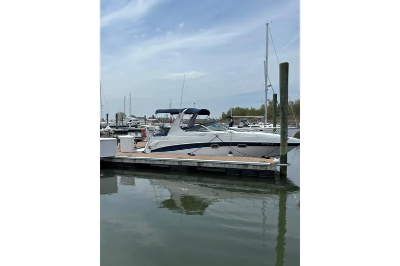 Slide: The Image of 2004 Four Winns 268 Vista boat docked at a marina on a calm day. - 41