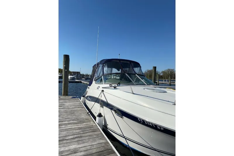 Slide: The Image of 2004 Four Winns 268 Vista boat docked at marina under clear blue sky. - 45