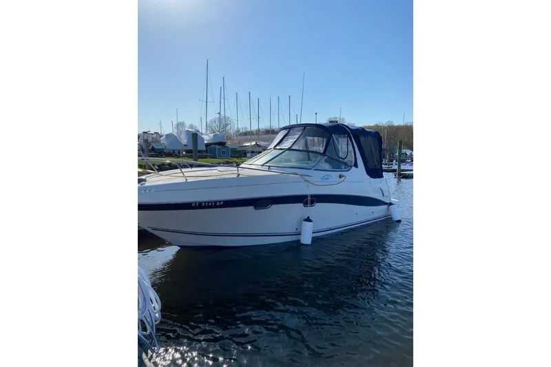 Slide: The Image of 2004 Four Winns 268 Vista boat docked in a marina under clear blue sky. - 46