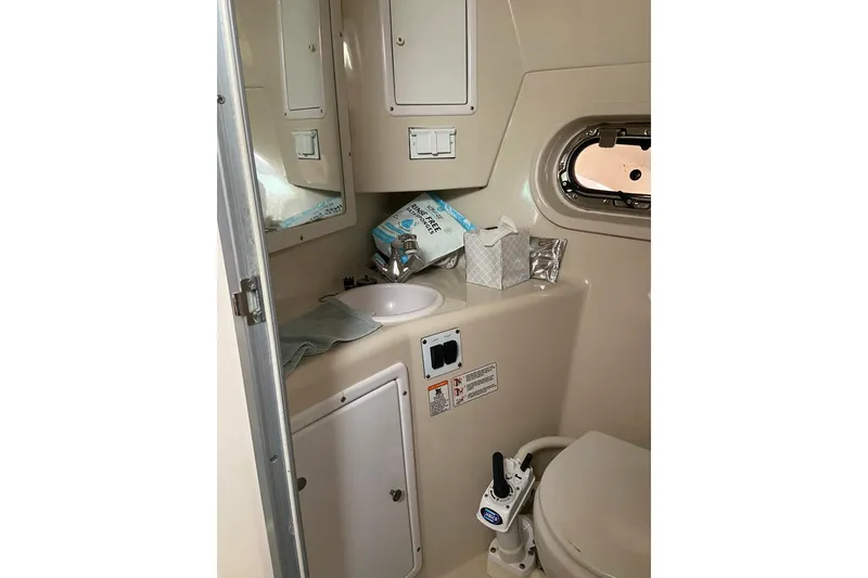 Slide: The Image of 2004 Four Winns 268 Vista boat bathroom with sink, mirror, and toilet. - 50