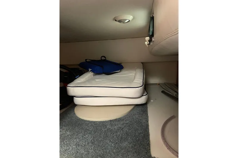 Slide: The Image of Interior cabin of 2004 Four Winns 268 Vista boat with cushions and storage. - 51