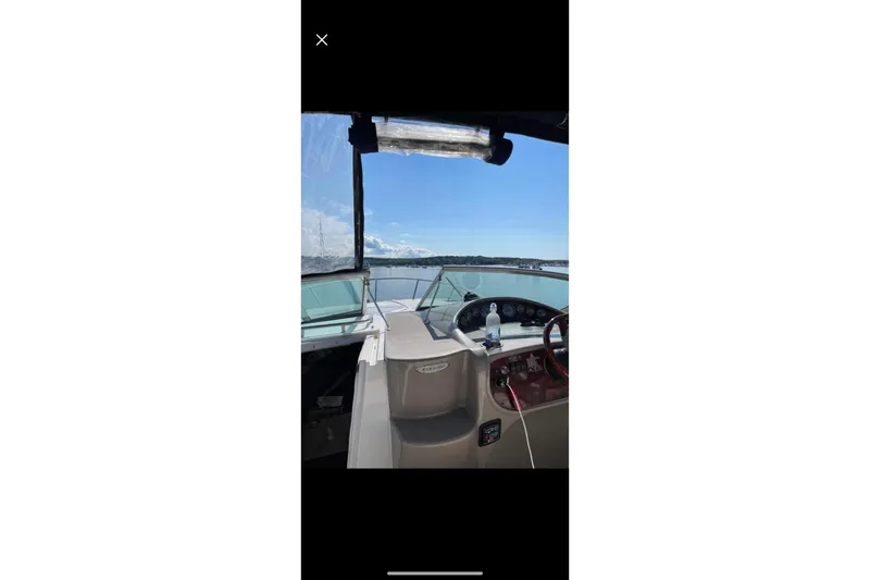 Slide: The Image of 2004 Four Winns 268 Vista boat interior with dashboard view on open water. - 60