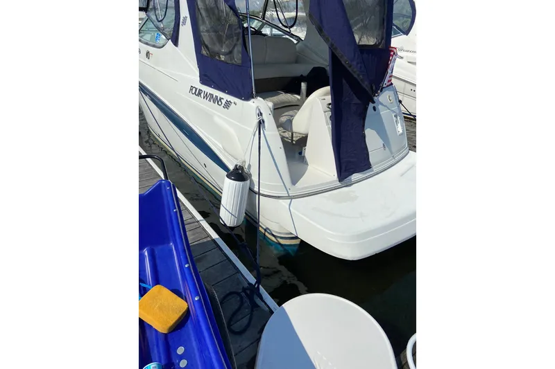 Slide: The Image of 2004 Four Winns 268 Vista boat docked with protective cover. - 64