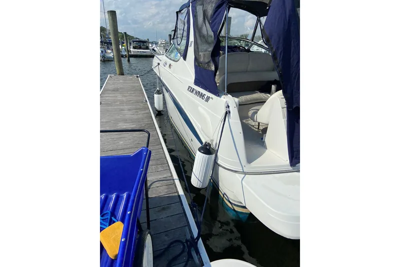 Slide: The Image of 2004 Four Winns 268 Vista boat docked at marina with blue canopy. - 65