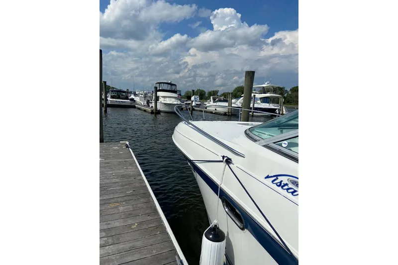 Slide: The Image of 2004 Four Winns 268 Vista boat docked at marina under cloudy sky. - 66