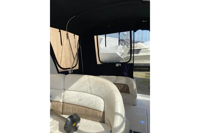 Slide: The Image of 2004 Four Winns 268 Vista boat interior with beige seating and window view. - 68