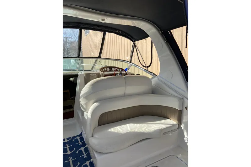 Slide: The Image of 2004 Four Winns 268 Vista boat interior with white seating and nautical-themed carpet. - 69