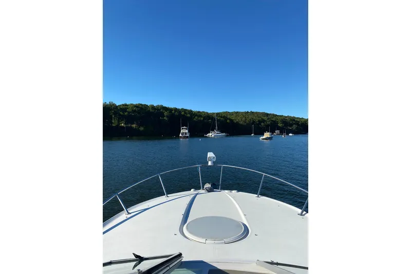 Slide: The Image of Bow view from a 2004 Four Winns 268 Vista boat on a serene lake. - 70