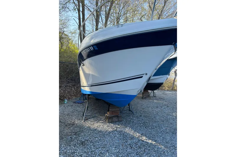 Slide: The Image of 2004 Four Winns 268 Vista boat on gravel, supported by stands. - 73