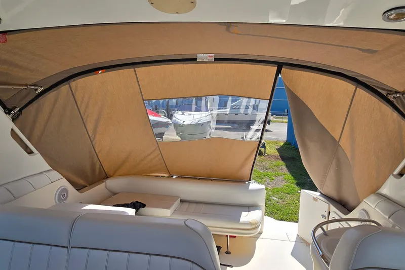 Slide: The Image of Interior view of 1998 Sea Ray 330 Sundancer with beige canopy and seating area. - 11