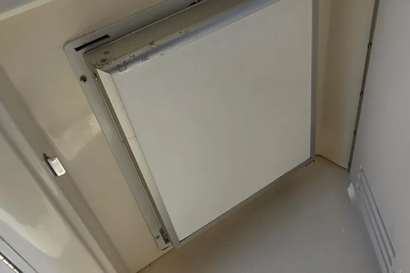 Slide: The Image of 1998 Sea Ray 330 Sundancer interior compartment with closed panel door. - 16