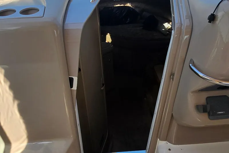 Slide: The Image of 1998 Sea Ray 330 Sundancer cabin entrance with beige interior and stainless steel handle. - 17