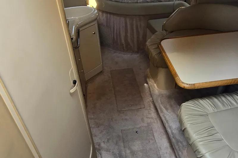 Slide: The Image of 1998 Sea Ray 330 Sundancer cabin interior with seating and table. - 18