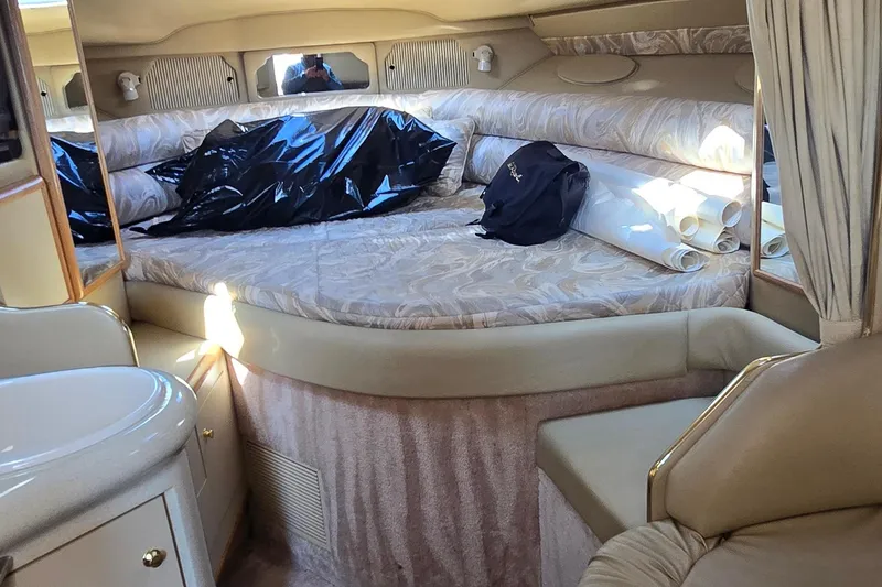 Slide: The Image of Interior of 1998 Sea Ray 330 Sundancer with bed, seating, and storage. - 24