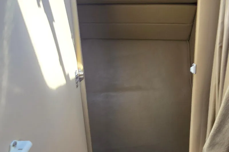 Slide: The Image of Interior cabin space of 1998 Sea Ray 330 Sundancer boat, featuring beige upholstery. - 28