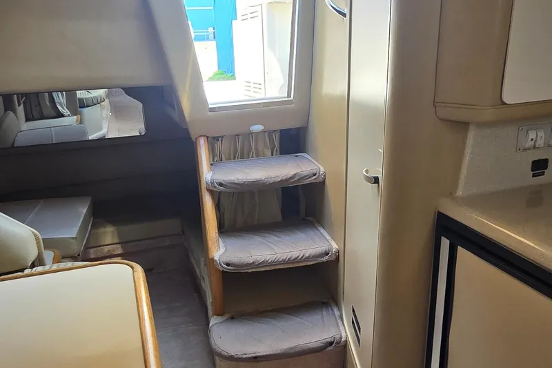 Slide: The Image of Interior of 1998 Sea Ray 330 Sundancer with stairs and seating area. - 30