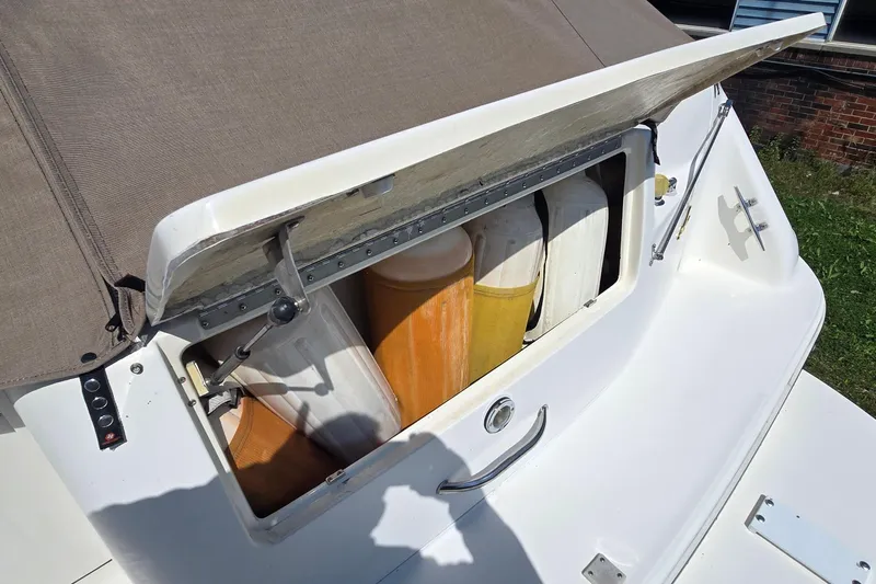 Slide: The Image of 1998 Sea Ray 330 Sundancer storage compartment with life jackets and equipment. - 31
