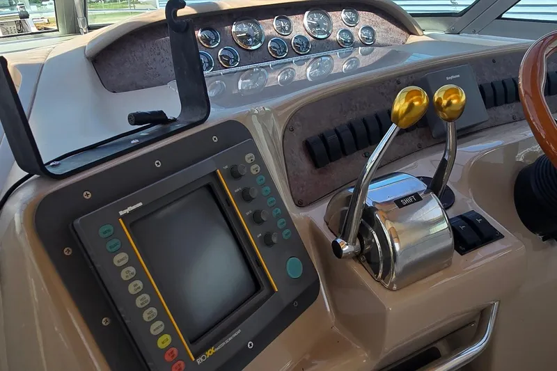 Slide: The Image of Control panel of a 1998 Sea Ray 330 Sundancer boat with navigation equipment. - 9