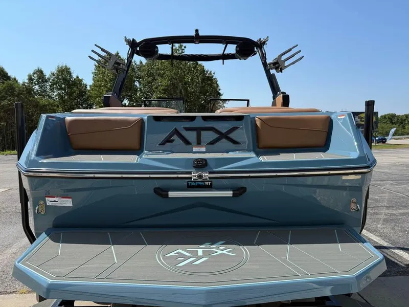 Slide: The Image of 2026 ATX Surf Boats 22 Type-S, rear view, blue with brown seats, parked outdoors. - 6