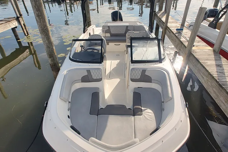 Slide: The Image of 2023 Bayliner VR6 Bowrider OB docked, showcasing spacious seating and sleek design. - 3