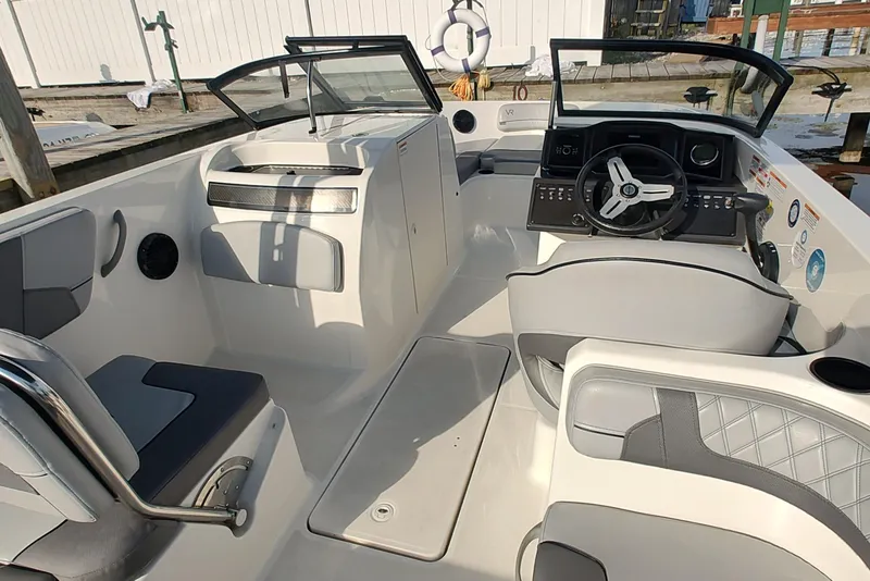 Slide: The Image of 2023 Bayliner VR6 Bowrider OB interior with modern dashboard and seating. - 7