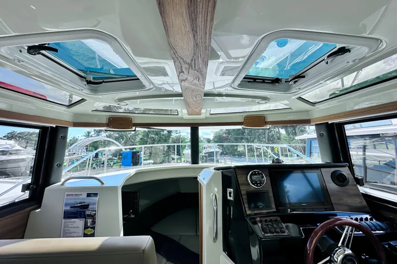 Slide: The Image of Interior view of 2026 Ranger Tugs R-25 boat cockpit with modern controls and skylights. - 12