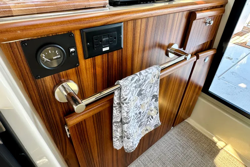 Slide: The Image of Interior of 2026 Ranger Tugs R-25 with wood finish and towel rack. - 22